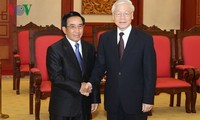  Party General Secretary receives Lao Vice President 