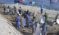 Vietnam Coast Guard stand side by side with Ly Son fishermen