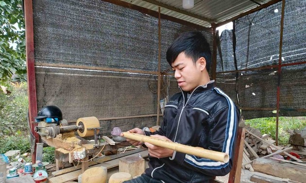 Young ethnic minority man passionate about traditional musical instrument 