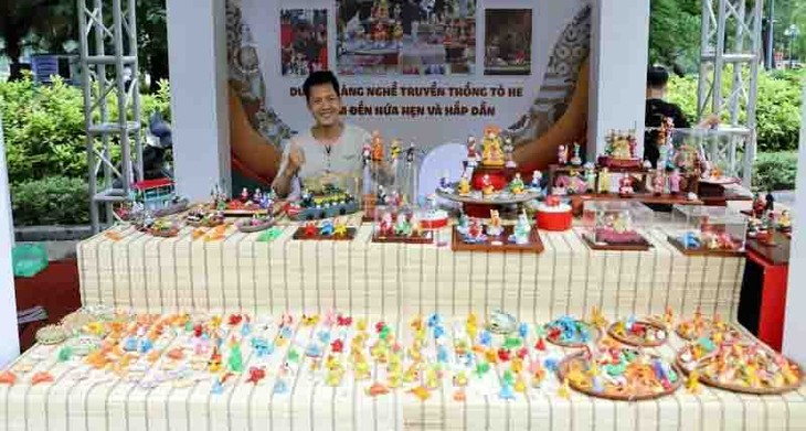 Un joven artesano que aprecia el valor del juguete tradicional “Tò he” - ảnh 1