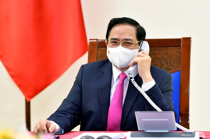 PM Pham Minh Chinh Lakukan Pembicaraan Telepon dengan PM Jepang, Suga Yoshihide - ảnh 1