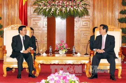 Une délégation du Laos reçue par les dirigeants vietnamiens à Hanoï  - ảnh 1