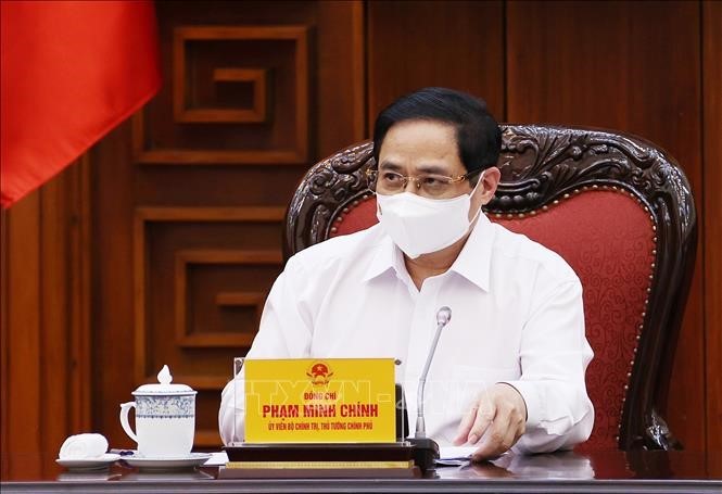 Pham Minh Chinh à la réunion de la permanence du gouvernement sur la lutte anti-Covid-19 - ảnh 1